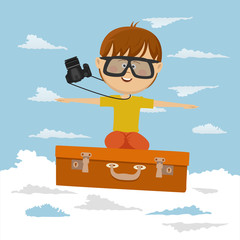 Cute little boy flying on suitcase on background of blue sky