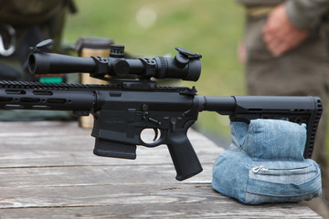 Sniper rifle. Horizontally. On the table in the forest.