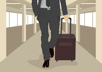 Close up of businessman carrying suitcase while walking at international airport