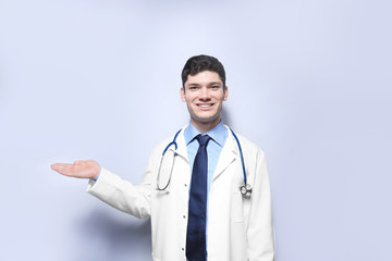 Handsome young doctor on white background