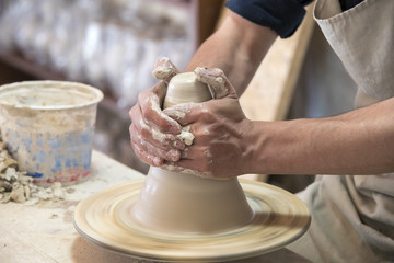 Potter makes pottery handmade in the workshop 