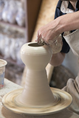 Potter makes pottery handmade in the workshop 