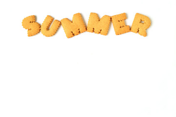 Top view of the word SUMMER, made with alphabet shaped biscuits isolated on white background, with free space for design and text 