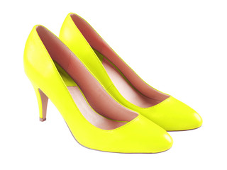Spike yellow leather high heels isolated on white