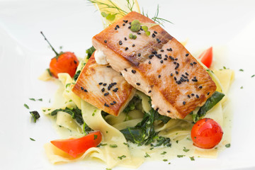 Salmon with vegetable tagliatelle served in a restaurant