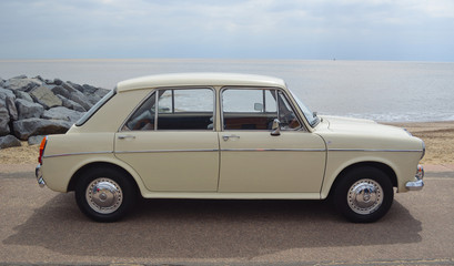  Classic Cream  Coloured  Austin 1100 MG Motor Car parked on seafront promenade.