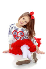 The little girl in the red skirt.