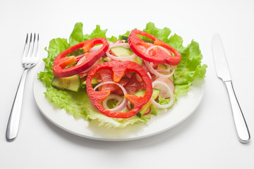 Vegetable Salad as a heart, vegetarian, lettuce, pepper, cucumber, radish, onion, tomato, celery, fork knife, white background

