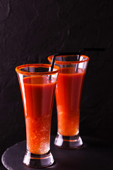 Bloody Mary cocktail with chili pepper, ice and celery.