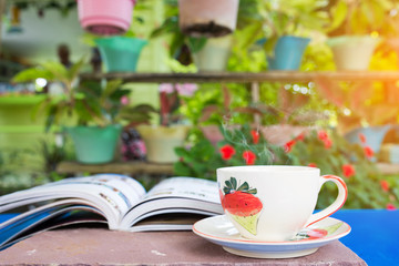 cup of coffee with book in the garden