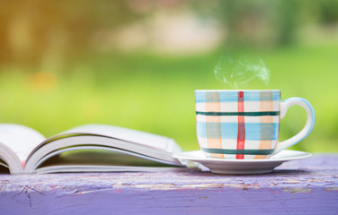 cup of coffee with book in the garden