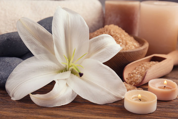 Fototapeta na wymiar Lily with spa stones and candles, closeup