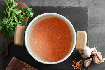 Pan with lentil and other products on table, top view