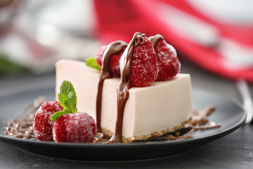 Tasty cheesecake slice with berries on plate