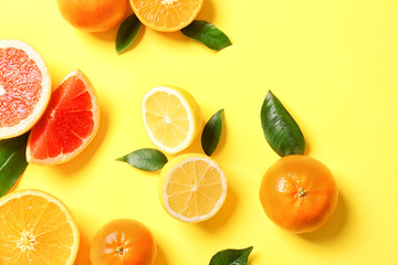 Juicy composition of tropical fruits on yellow background