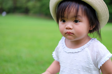 Cute Baby girl playing in the garden, close-up portrait, Portrait of Asian beautiful baby girl of 1 year and 3 months old.