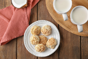Plate with delicious coconut macaroons on table