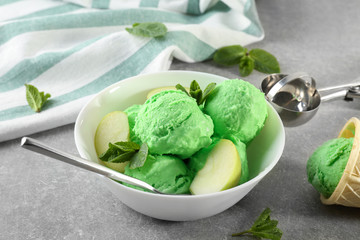 Bowl with tasty fruit ice cream on table