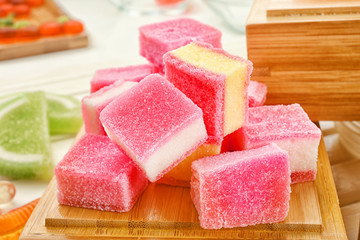 Tasty jelly candies and wooden box, closeup