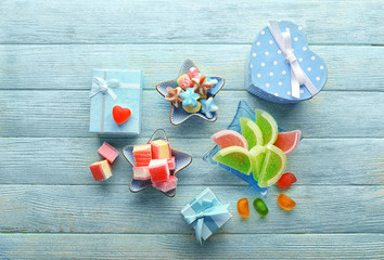 Composition with tasty jelly candies on wooden background