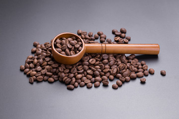 Coffee bean and spoon on a black background