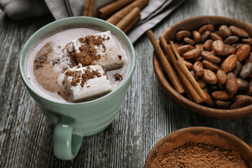 Composition with tasty cocoa drink on wooden table