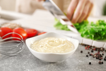 Delicious mayonnaise in bowl on kitchen table
