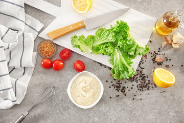 Delicious mayonnaise in bowl on kitchen table, top view