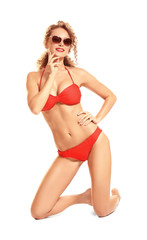 Beautiful young woman in bikini on white background