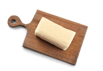 Board with butter on white background, closeup