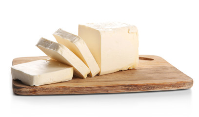 Board with butter pieces on white background, closeup