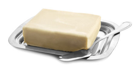 Dish with butter and shovel on white background