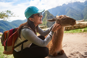 Tourist woman play with lama