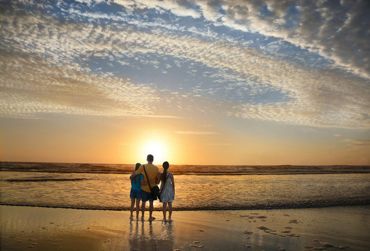 Family Enjoying Time On The Beach At Sunrise, Jacksonville, Florida, USA.