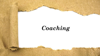 Torn paper with word "coaching"