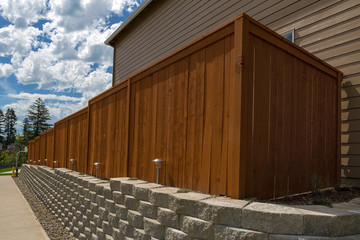 Wood Fence and Cement Blocks Retaining Wall - 151946296