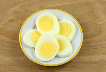 Hard boiled egg slices on small white plate