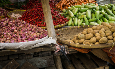 red onion potato cucumber and red chilli with bamboo wooden basket on traditional market in bogor indonesia