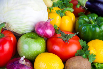 Close-up of fruits and vegetables. Cabbage, tomato, apple, pepper, herbs, onions, kiwi, lemon