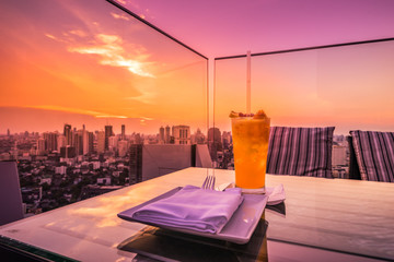 abstract yellow cocktail on rooftop bar and cityscape view - can use to display or montage on...