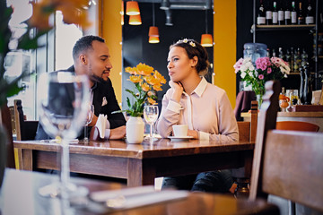 Black couple drinking wine.