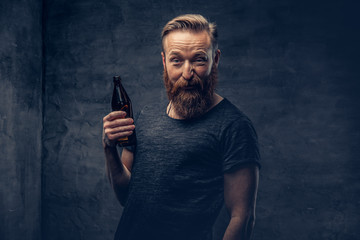 A man holds beer bottle.