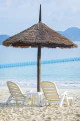 couples of white chairs on traveling destination sea beach