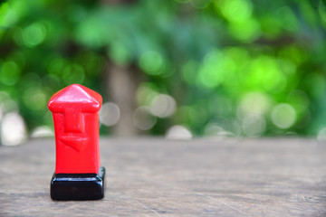red mail box on green nature background.