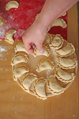 potato dumplings  ( Vareniki) .  traditional dish of Russian and Ukrainian cuisine. Rolling pin for dough and raw dumplings. Making Vareniki