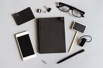 Blank notebook with smart phone on desk office