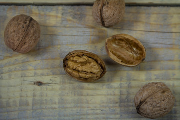 Shelled and peeled nuts on a wooden background