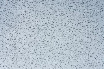 Gray shiny surface in drops of water. Background.