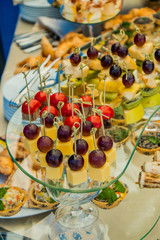 Assortment of canapes with meat, fruits and vegetables. Banquet service buffet