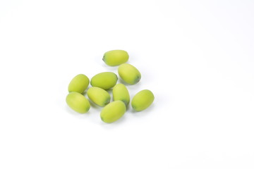 Green lotus seeds on a white background.